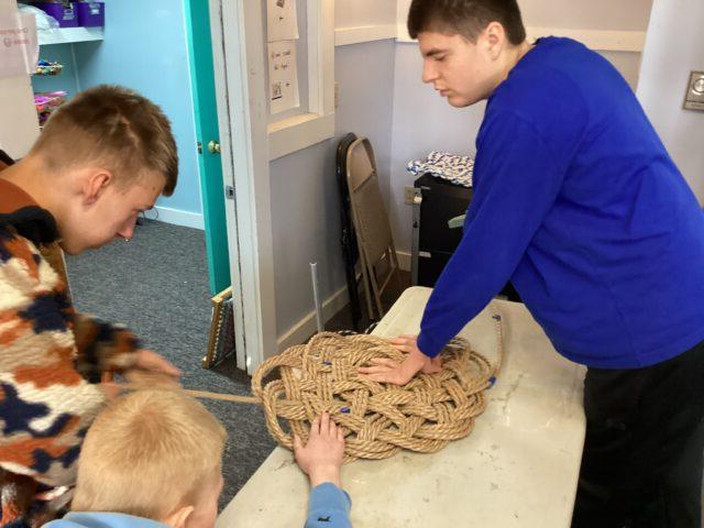 Students work in our Vocational Room weaving mats
